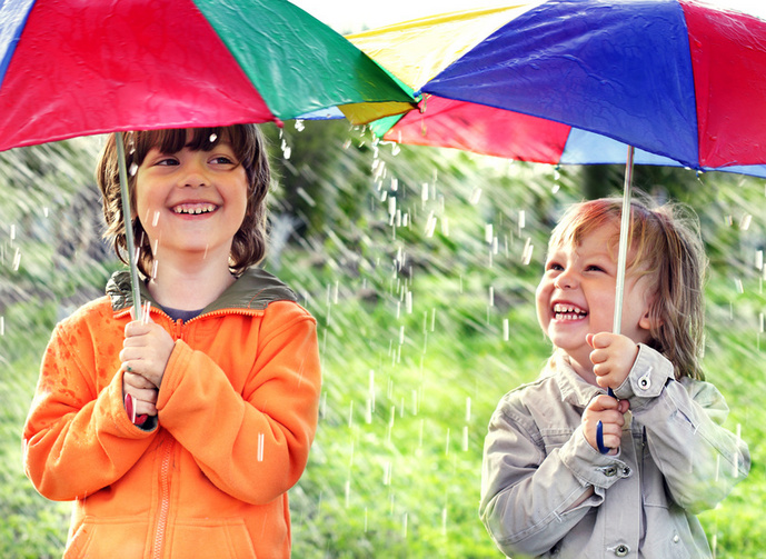 two happy brother with umbrella outdoors